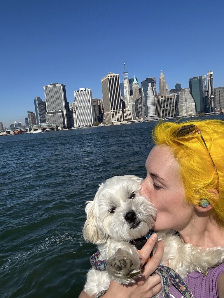 Britta and a dog with the Lower Manhattan skyline behind